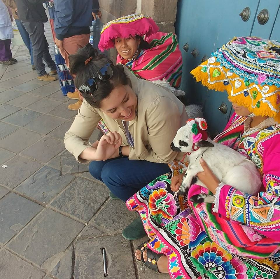 Picture of Brianna in Peru petting a baby goat